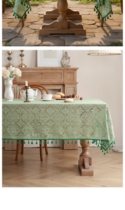 Detailed texture of French vintage light green lace tablecloth with elegant tassels