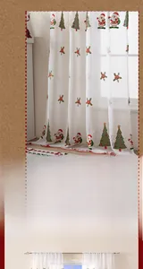 Detail of white sheer Christmas curtain featuring Santa and tree embroidery with red trim