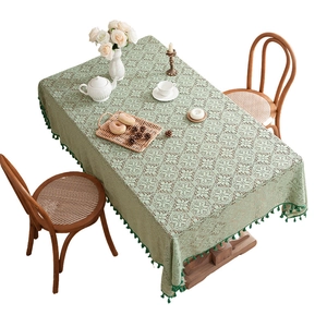 Pale green lace tablecloth with vintage floral patterns and dark green tassels
