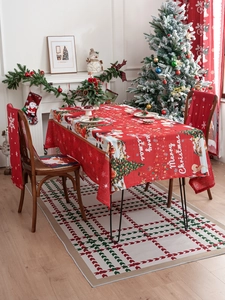 Classic red Christmas tablecloth featuring Santa and tree patterns for holiday dining