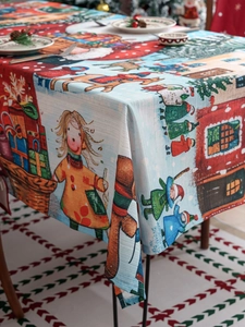 Detailed view of Christmas tablecloth with snowman and reindeer hand-drawn patterns