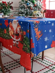 Detailed fabric texture of Christmas tablecloth with Santa and reindeer patterns
