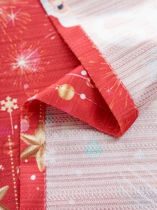 Close-up of Christmas tablecloth showing coarse texture, stars and snowflake patterns