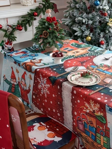 Detail of Christmas tablecloth and chair covers featuring snowmen and winter scenery