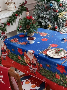 Detailed texture of waterproof Christmas tablecloth with Santa and reindeer motifs