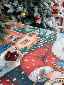 Detail of Christmas tablecloth showing snowy house prints and textured fabric weave