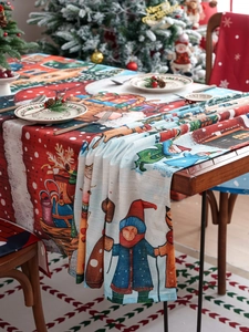 Detail of Christmas tablecloth with Santa and snow scene patterns for festive dining decor