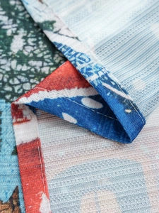 Macro detail of Christmas tablecloth showing textile texture and premium stitched hem edge