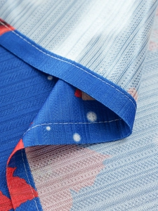 Close-up of American Christmas tablecloth with blue webbing edge and grid weave texture
