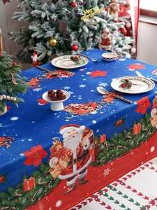 Detail of waterproof Christmas tablecloth with Santa and reindeer prints on blue background