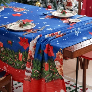 Waterproof Christmas tablecloth with Santa and poinsettia prints on royal blue fabric