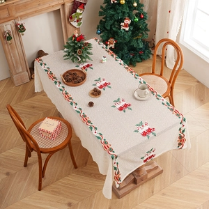 Rectangular Christmas tablecloth with holly leaf patterns and festive sock prints on ivory fabric