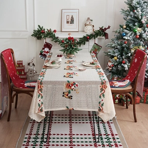Christmas tablecloth and chair covers set featuring embroidered Santa and reindeer motifs