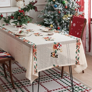 Embroidered Christmas lace tablecloth featuring Santa and reindeer motifs for holiday dining