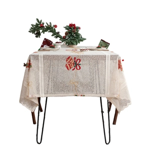Christmas lace tablecloth with red bells and golden bows embroidery on white background