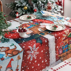 Christmas tablecloth featuring festive Santa, reindeer and snowflakes on a dining table