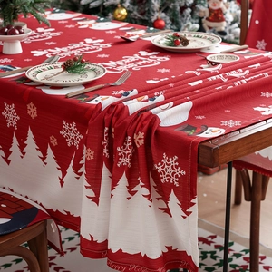 Christmas tablecloth with red snowman and snowflake patterns and matching chair cushions
