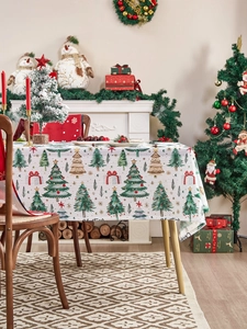 Macro detail of Christmas tablecloth fabric with festive tree and gift box print patterns