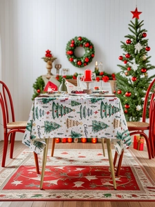 Detailed texture of white Christmas tablecloth featuring green trees and star patterns