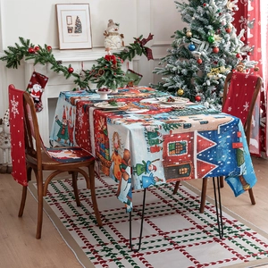 Detail of Christmas tablecloth featuring festive cartoon illustrations and warm holiday decor