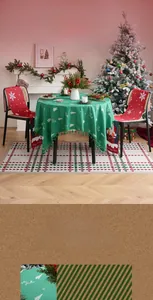 Close-up of green Christmas tablecloth with white deer embroidery and tassel fringe