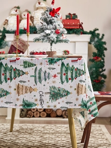 Close-up of rectangular Christmas tablecloth with hand-drawn tree patterns and texture