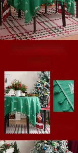Detail of Christmas tablecloth featuring white reindeer embroidery and green fringe tassels
