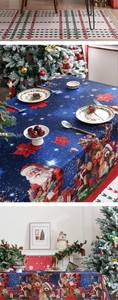 Detailed view of dark blue Christmas tablecloth with Santa, reindeer and festive prints