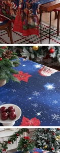 Detail of Christmas tablecloth featuring Santa and teddy bear on navy textured fabric