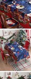 Detail of Christmas tablecloth with Santa Claus and Teddy Bear prints and chair cushions