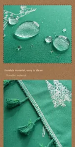 Close-up of reindeer embroidery and waterproof fabric on a green Christmas tablecloth