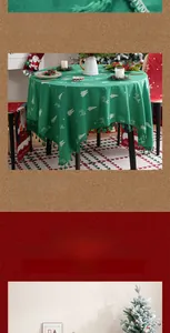 Detail of Christmas tablecloth with white reindeer embroidery and green pom-pom fringe edges