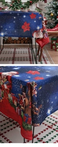 Detailed close-up of dark blue Christmas tablecloth with nutcracker and Santa Claus prints