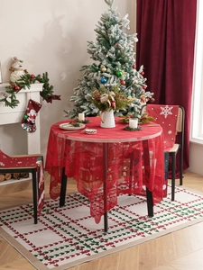 Close-up detail of red Christmas lace tablecloth and festive printed chair covers