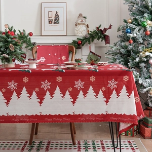 Christmas tablecloth in festive red with snowflake patterns and forest silhouette design