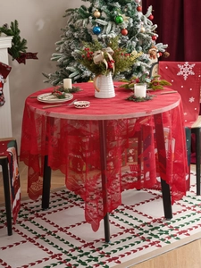 Detail of red Christmas lace tablecloth with snowflake and reindeer hollow patterns
