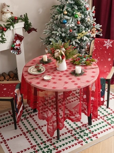 Detailed view of red Christmas lace tablecloth and chair covers with snowflake motifs