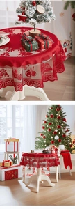 Detail of red hollow lace Christmas tablecloth featuring bell patterns and festive decor