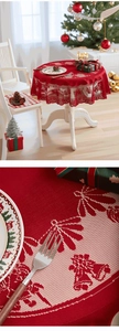 Detailed knit texture of red Christmas lace tablecloth with festive bell and pine patterns