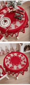 Detailed view of red Christmas tablecloth with hollow lace edges and festive knit patterns