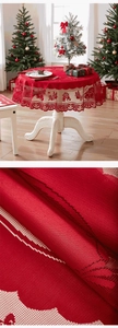 Detail of red Christmas lace tablecloth with bell embroidery and wavy scalloped edges