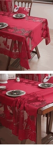 Detail of red Christmas lace tablecloth with hollow bells and star patterns for holiday decor