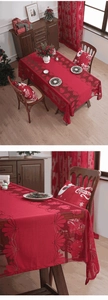 Detail of red Christmas lace tablecloth featuring delicate bell jacquard and scalloped edges