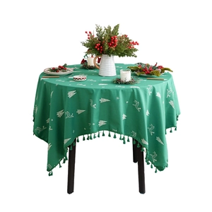 Green round Christmas tablecloth with reindeer embroidery and decorative edge tassels