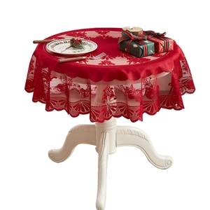 Red Christmas lace tablecloth featuring festive bells and trees on a round white table