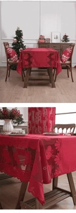 Detailed close-up of red Christmas lace tablecloth with festive reindeer and star patterns