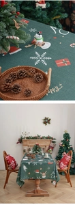 Close-up of Christmas tablecloth fabric with reindeer and snowflake print detail