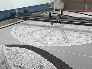 Detail showing high-end lace embroidery fabric production on industrial machines