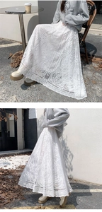 Close-up of white lace skirt featuring paisley embroidery and elegant scalloped hemline