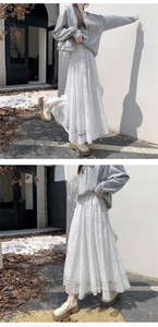 Detail view of floral hollow lace maxi skirt with elegant high-waist layered texture